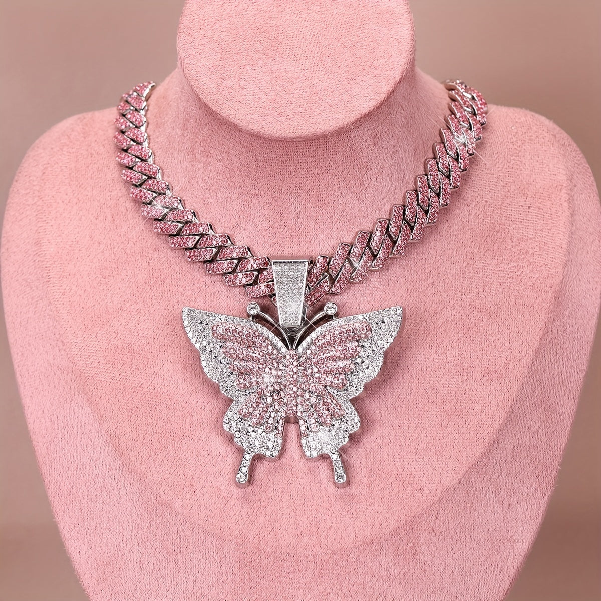 An Icy Chain And A Large Pink Rhinestone Butterfly Pendant