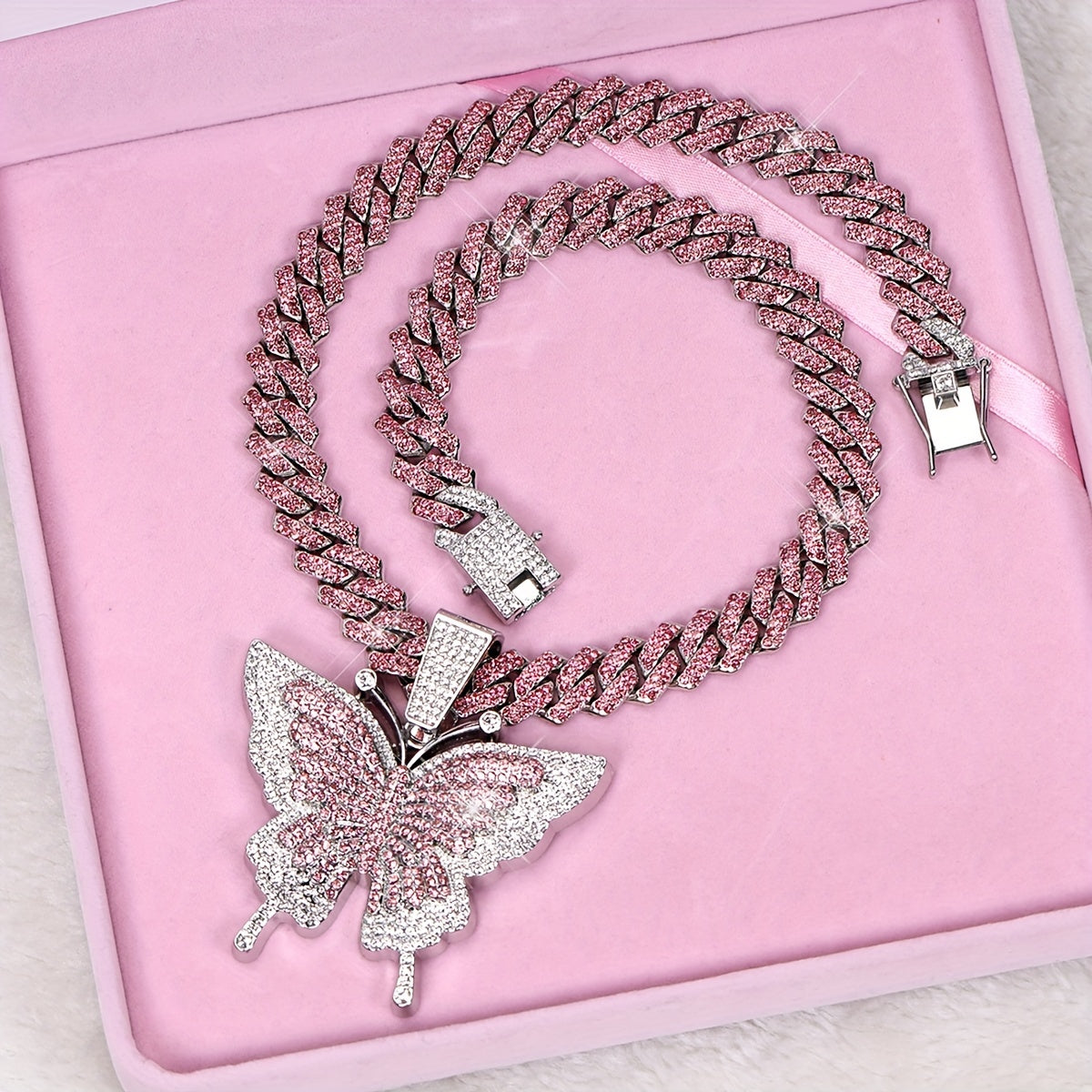 An Icy Chain And A Large Pink Rhinestone Butterfly Pendant